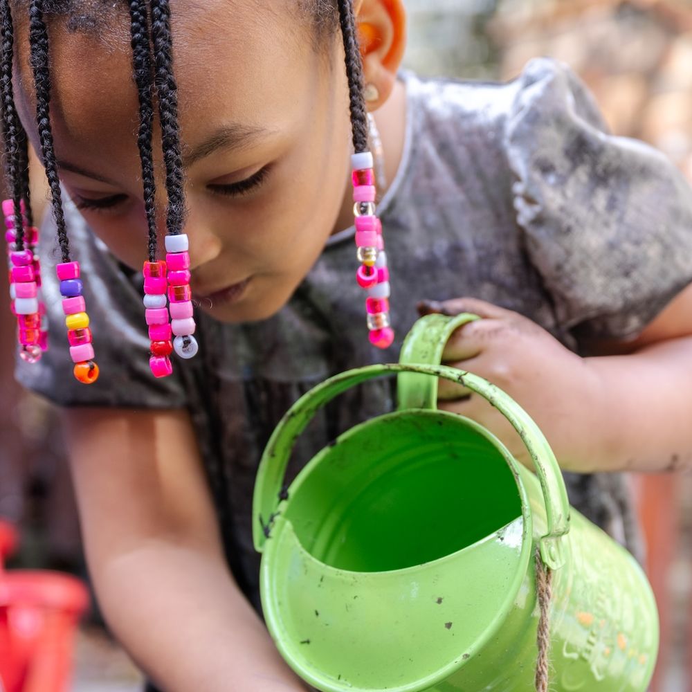 Girl with watering can landscape