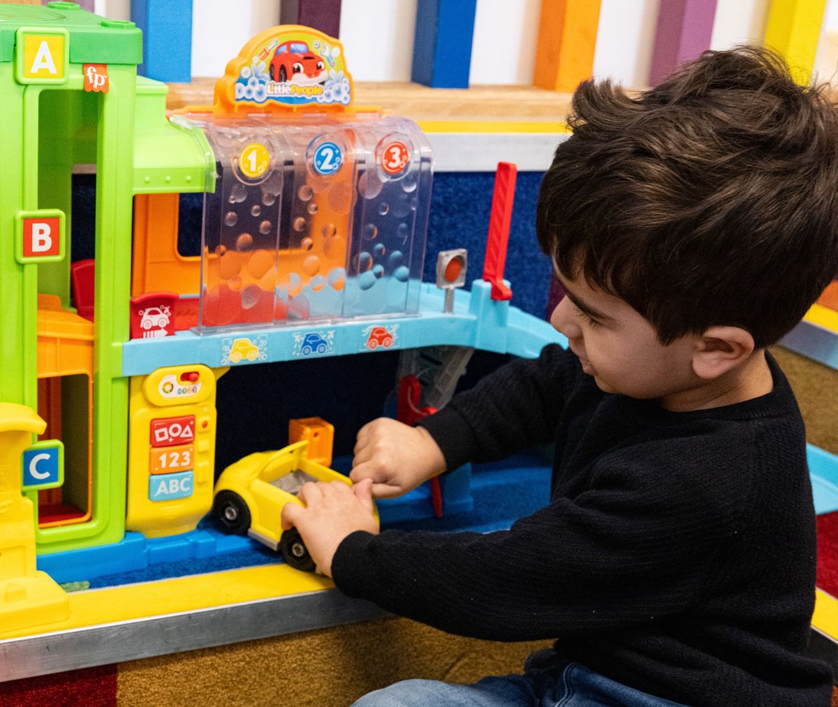 Boy playing with toy cars