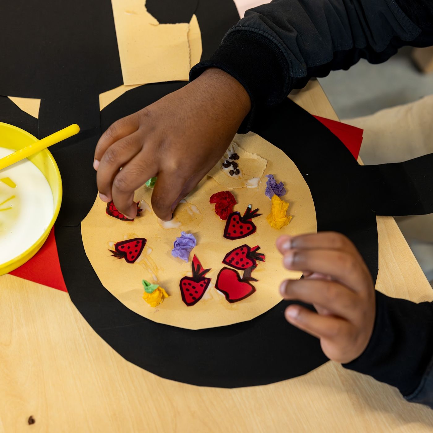 Child making a paper pizza