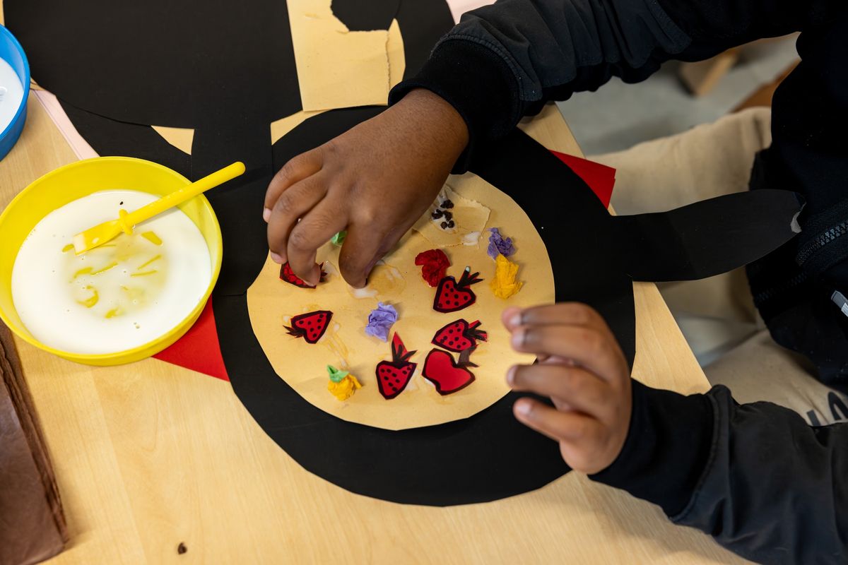 Child making a paper pizza