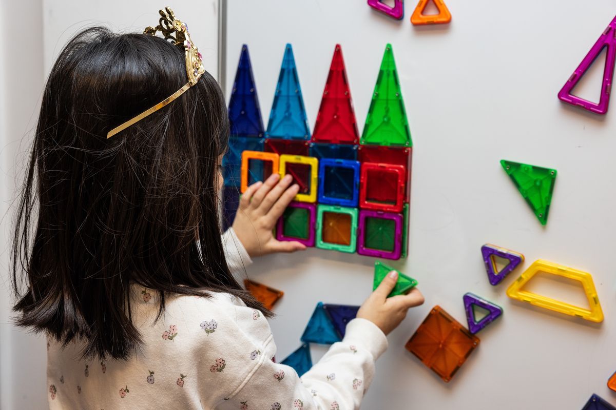 Child playing with magnetic toys