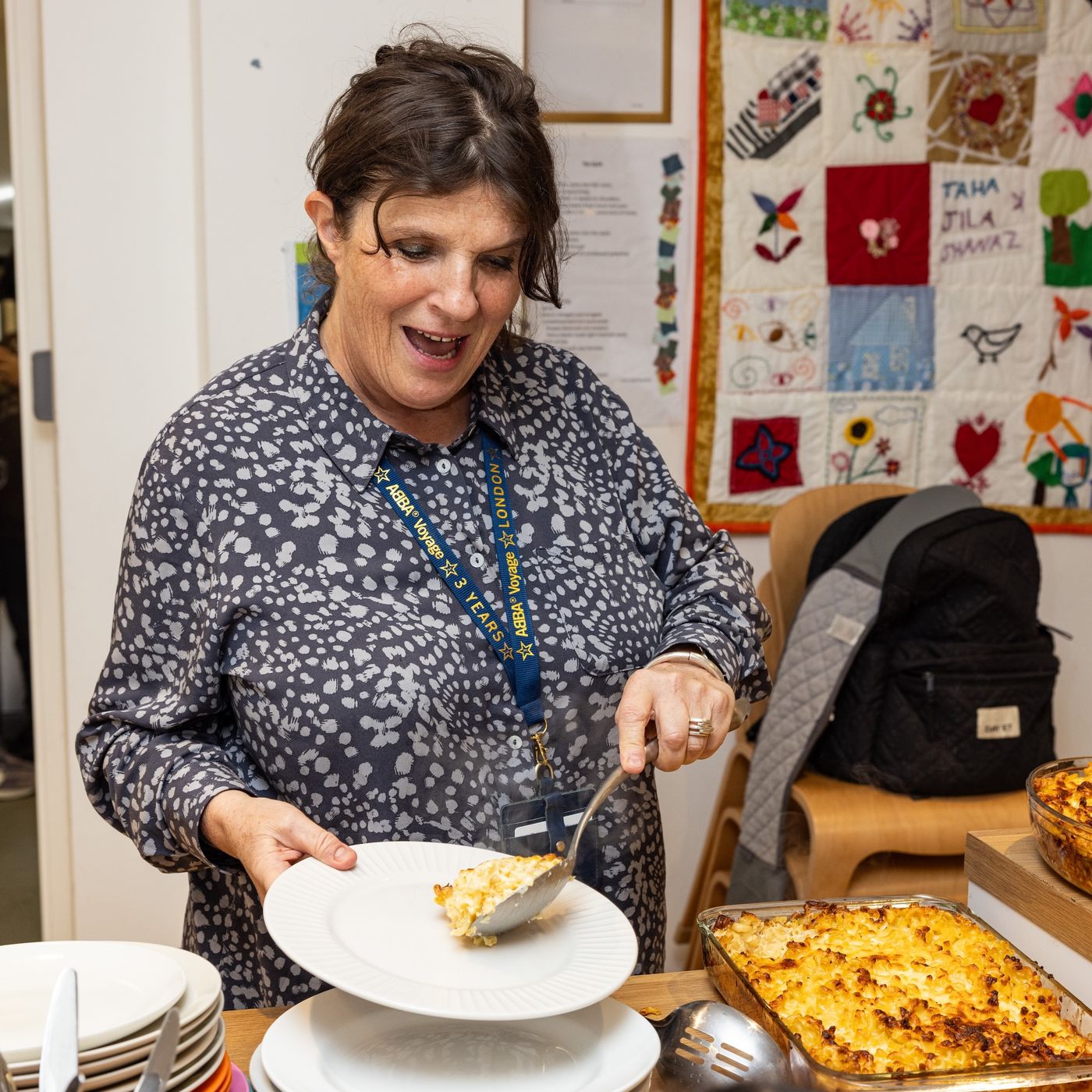 Family services worker serving food to children