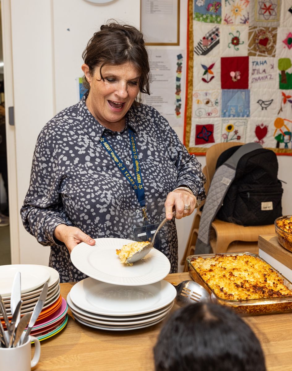 Family services worker serving food to children