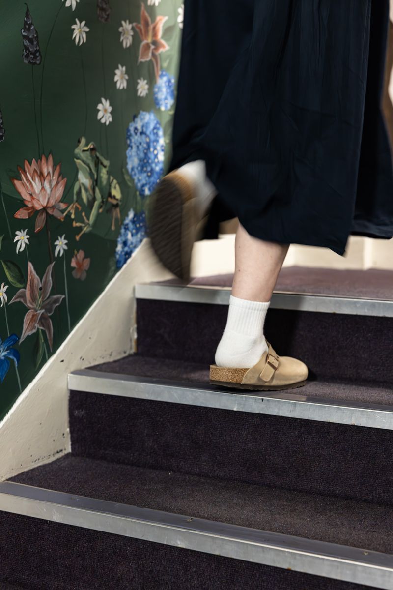 Person climbing hostel stairs