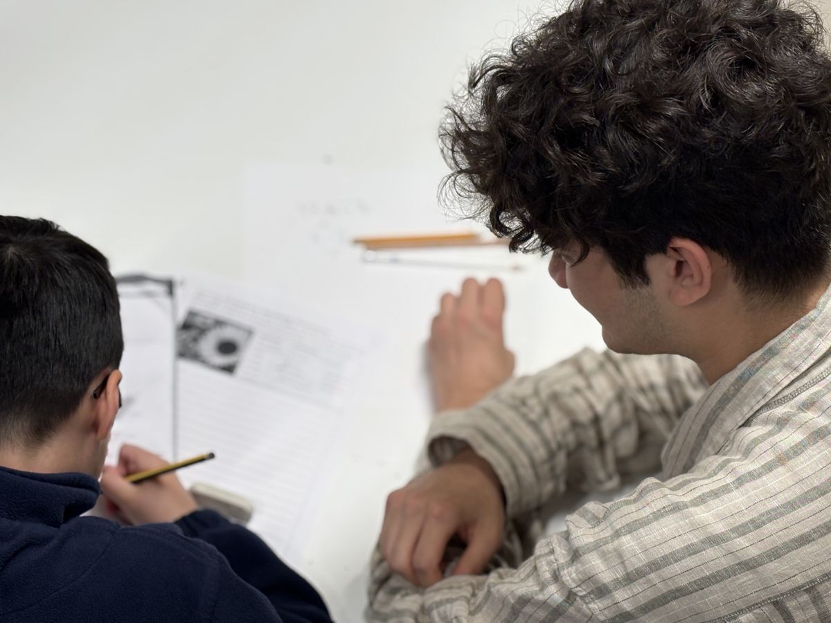 Volunteer with child at homework club